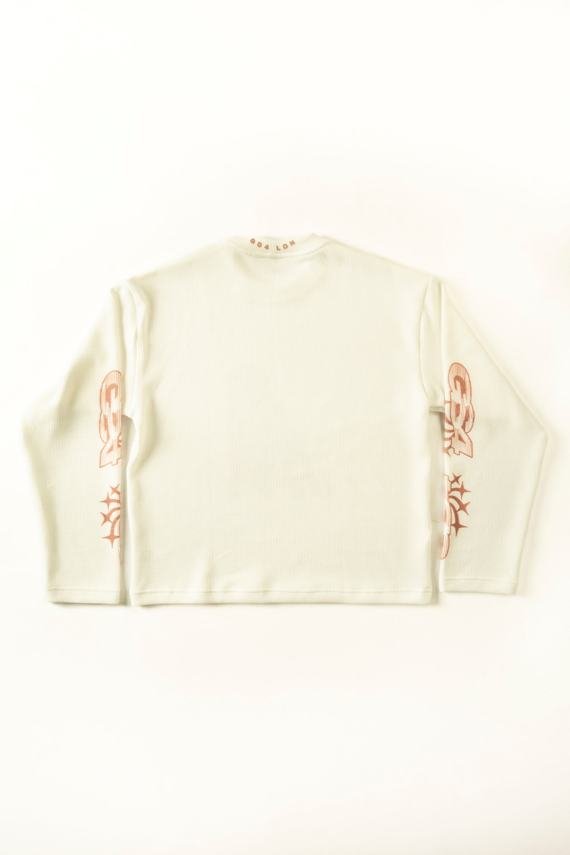 White sweater with red patterns on a white background